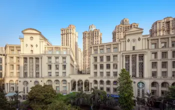 Neoclassical-style commercial buildings with intricate detailing, set against a backdrop of modern high-rise towers.