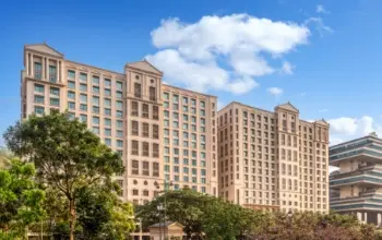 Modern office complex with a glass facade and landscaped surroundings.