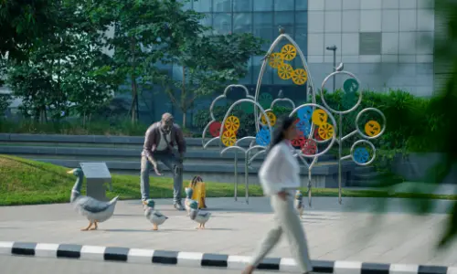 View of the Candor TechSpace buildings with glass facades and landscaped spaces at the ground level, located in Sector 135, Noida.