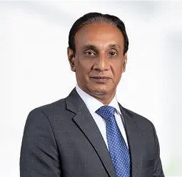 Sanjay Yadav, Senior Vice President - Regulatory Affairs and Compliance, stands confidently in a professional suit, exuding authority and expertise in corporate governance.