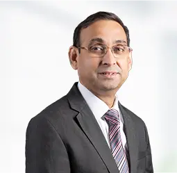 Munish Mathur, Senior Vice President & Regional Head - North, dressed in a professional suit and tie, exuding confidence and leadership in the regional management of the North sector.