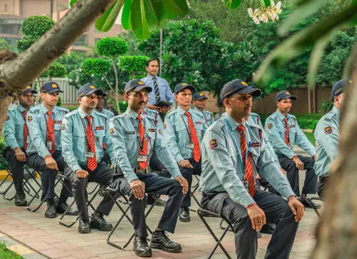 A group of security personnel in uniform sitting attentively during a training session at Candor TechSpace, Sector 62, Noida.