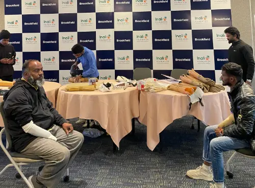 People participating in a health event, with some receiving treatment and others sitting, with tables full of medical supplies, at a Brookfield event.