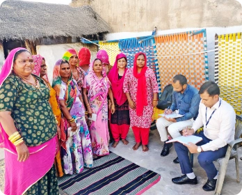 ICICI Bank representatives briefing SHG women in Nagaur, Rajasthan about loans.
            