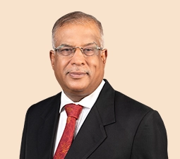 Portrait of Radhakrishnan Nair, Independent Director at ICICI Bank, wearing a black suit and red tie, showcasing his professional demeanor and role within the organization.