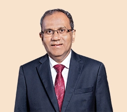 Portrait of B. Sriram, Independent Director at ICICI Bank, wearing a dark suit and red tie, showcasing his role as a senior leader within the organization.