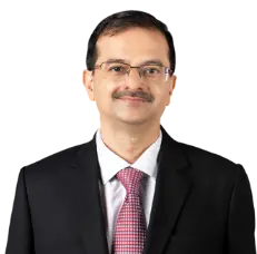 A professional portrait of Rakesh Jha, the Executive Director of ICICI Bank, wearing a formal dark suit, white shirt, and red patterned tie, standing against a neutral background. The text below his image reads Rakesh Jha, Executive Director in white text on a red background.