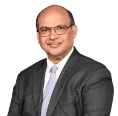 A professional portrait of Ajay Kumar Gupta, the Executive Director of ICICI Bank, dressed in a dark suit, white shirt, and light-colored tie, with a neutral background. The text below his image reads Ajay Kumar Gupta, Executive Director in white text on a red background.